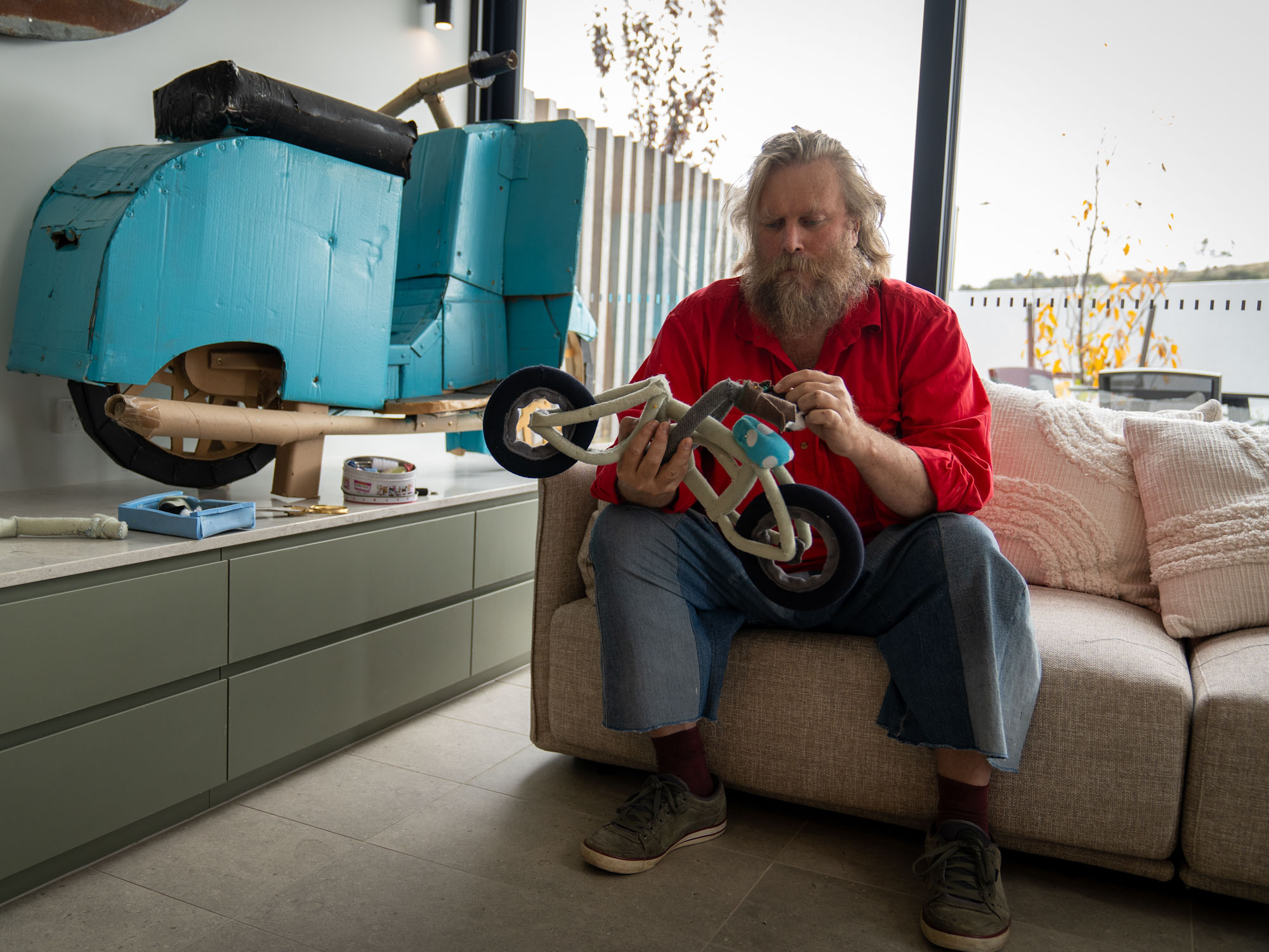 Man sitting on couch looking at art