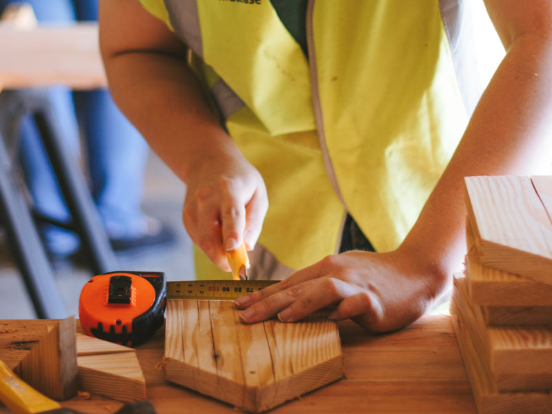person working with tools and wood