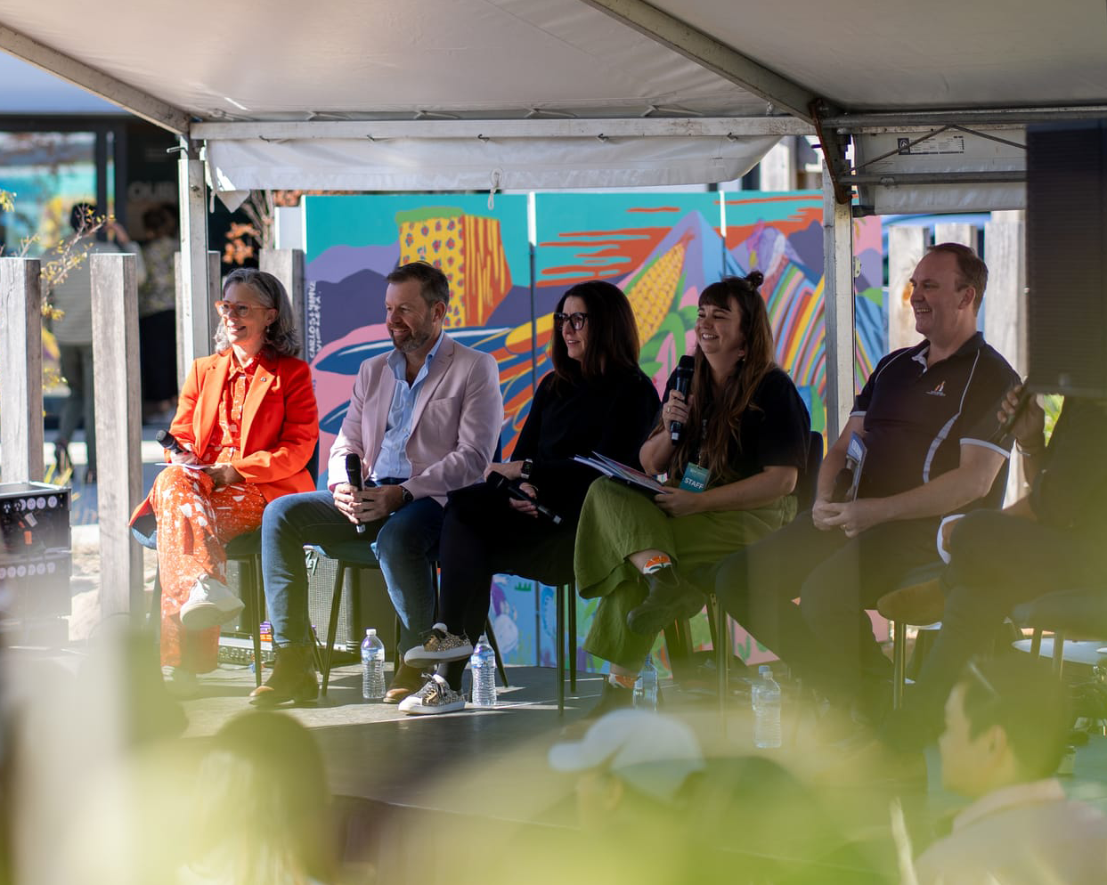 People sitting on stage talking