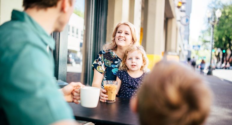 Family drinking coffee at cafe